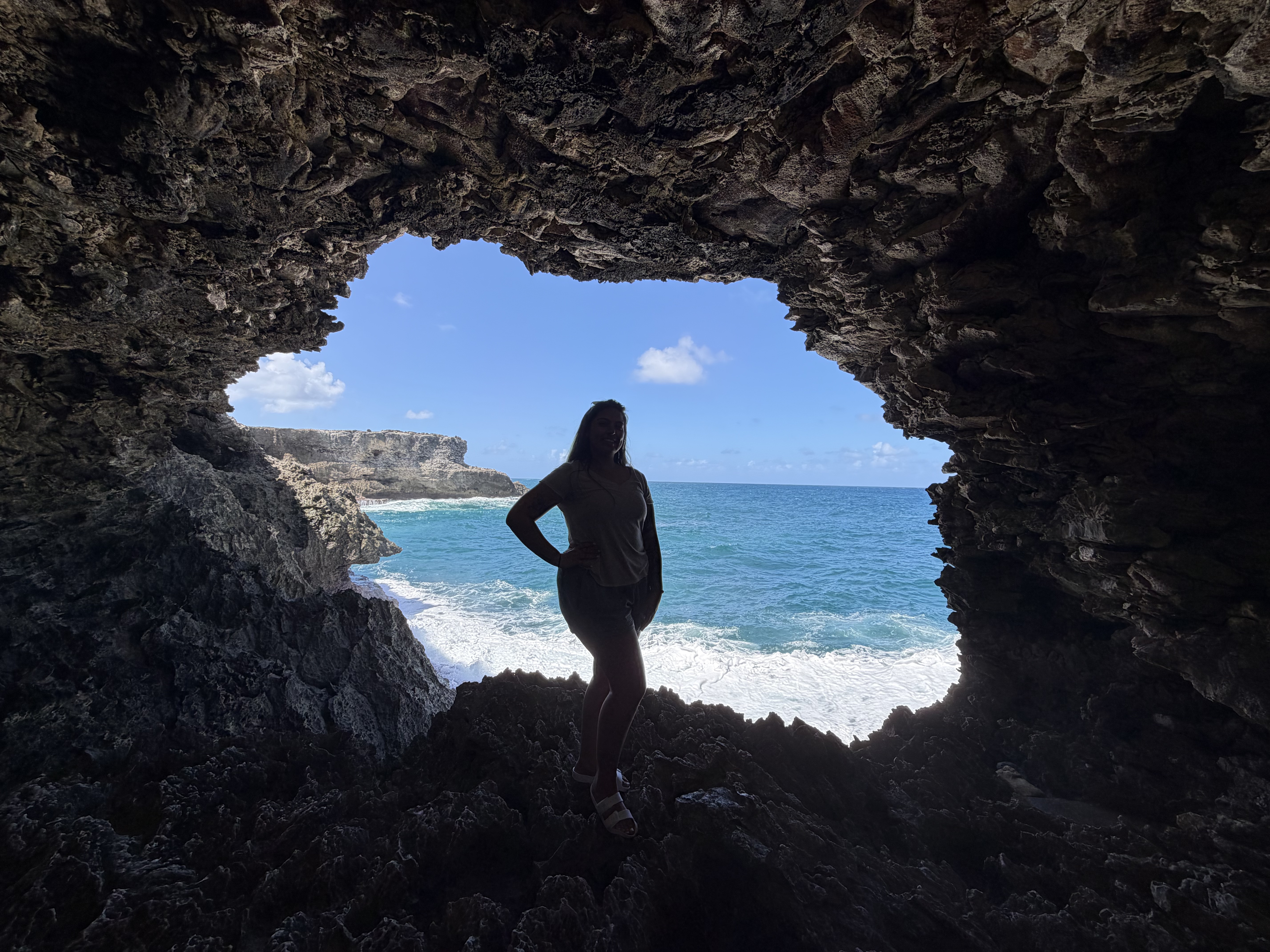 A dramatic sea cave opening onto a sparkling ocean view